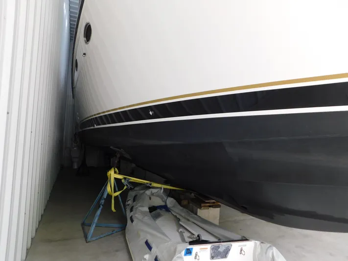 Sun Baked Yacht Photos Pics 1999 Tiara Yachts 3500 Express stored indoors, side view of hull and support.