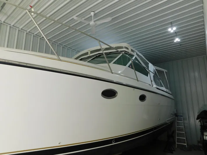 Sun Baked Yacht Photos Pics 1999 Tiara Yachts 3500 Express in storage, showcasing sleek design and white exterior.