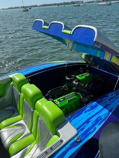  Yacht Photos Pics 2008 Outerlimits 39 Quattro speedboat with open engine compartment, vibrant green and blue design.
