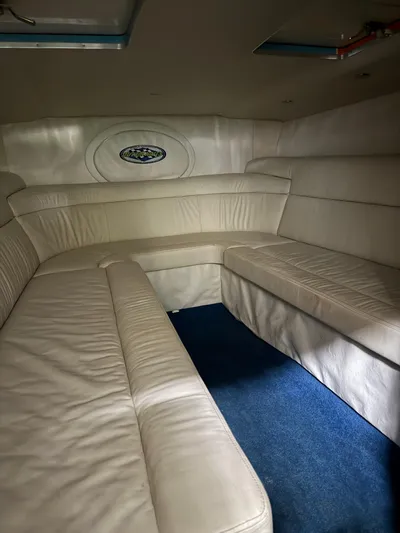  Yacht Photos Pics 2008 Outerlimits 39 Quattro interior with white leather seating and blue carpet.