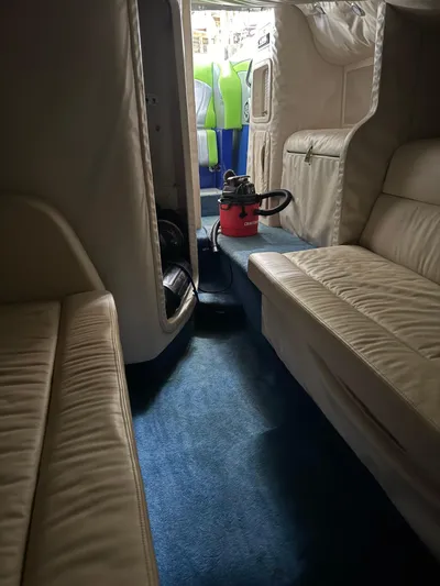  Yacht Photos Pics Interior of a 2008 Outerlimits 39 Quattro boat with beige seating and blue carpet.