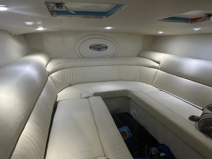  Yacht Photos Pics 2008 Outerlimits 39 Quattro interior with white leather seating and overhead lighting.