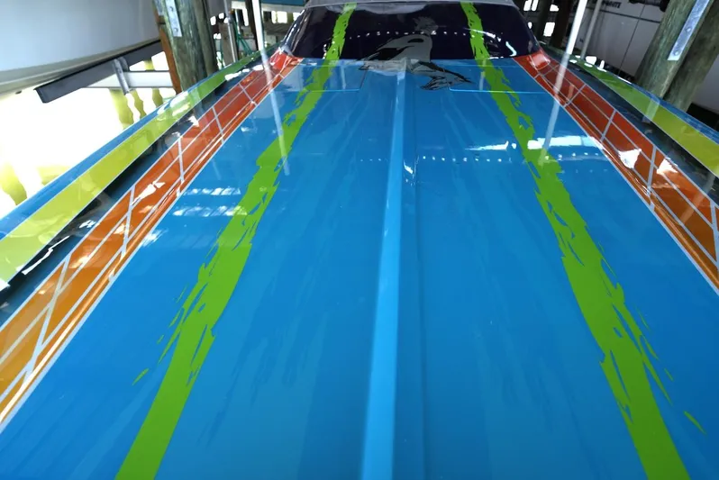  Yacht Photos Pics 2008 Outerlimits 39 Quattro boat with vibrant blue, orange, and green paint design.