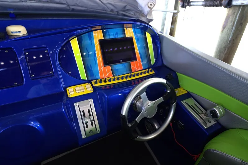  Yacht Photos Pics 2008 Outerlimits 39 Quattro cockpit with vibrant blue and green dashboard, steering wheel, and controls.