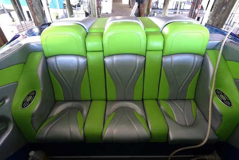 Yacht Photos Pics 2008 Outerlimits 39 Quattro boat seats, green and gray upholstery, docked setting.