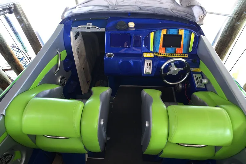  Yacht Photos Pics 2008 Outerlimits 39 Quattro cockpit with vibrant green and blue seating and dashboard.