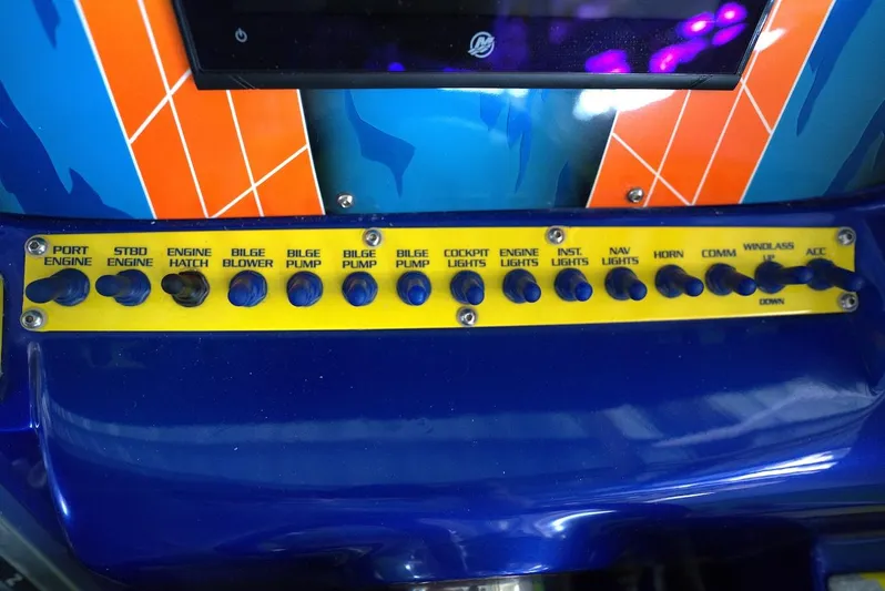  Yacht Photos Pics Control panel of a 2008 Outerlimits 39 Quattro boat with labeled switches.