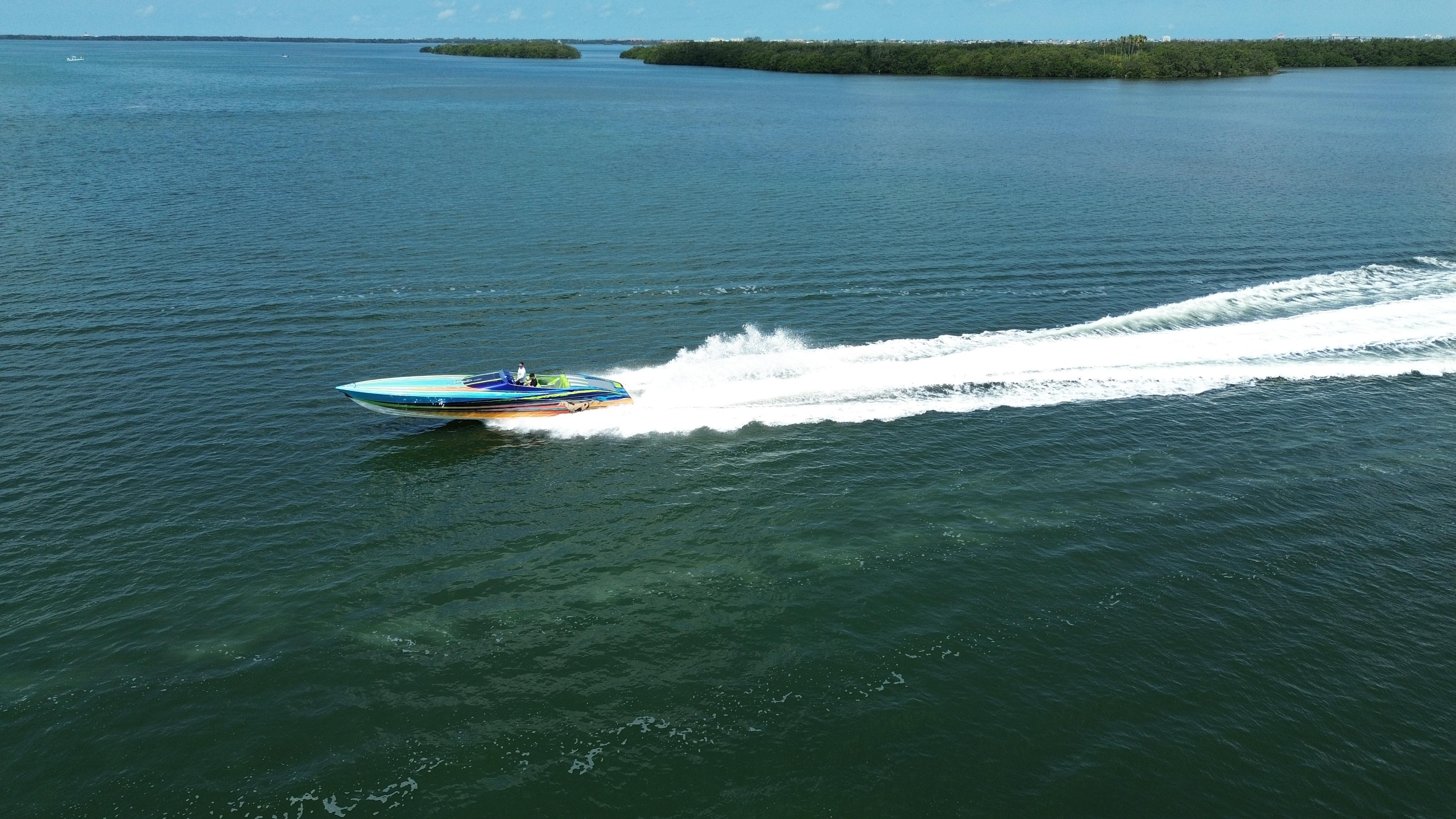 2008 Outerlimits 39 Quattro speedboat cruising on open water, leaving a white wake trail.