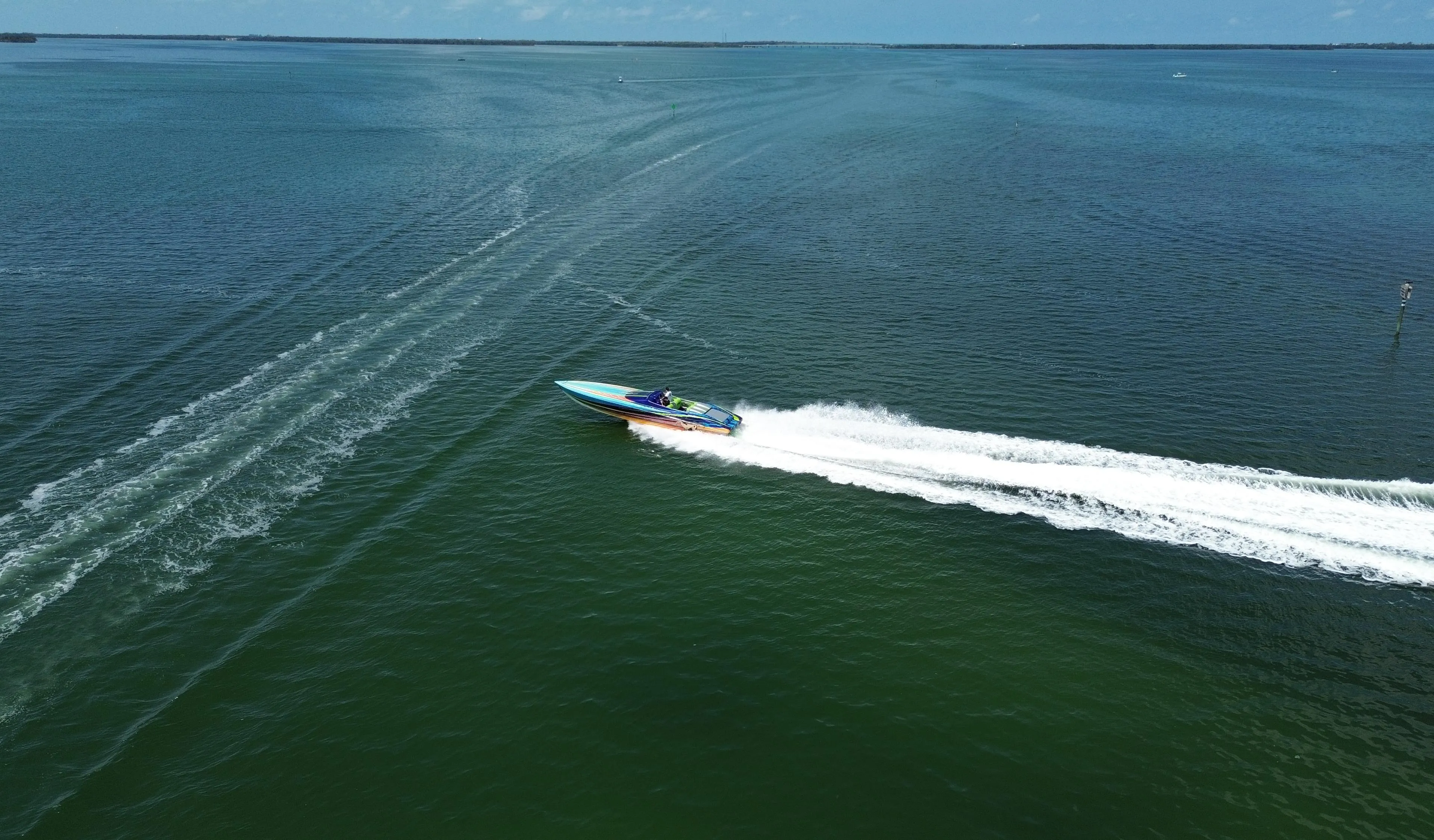 2008 Outerlimits 39 Quattro speedboat cruising on open water, leaving a white wake trail.