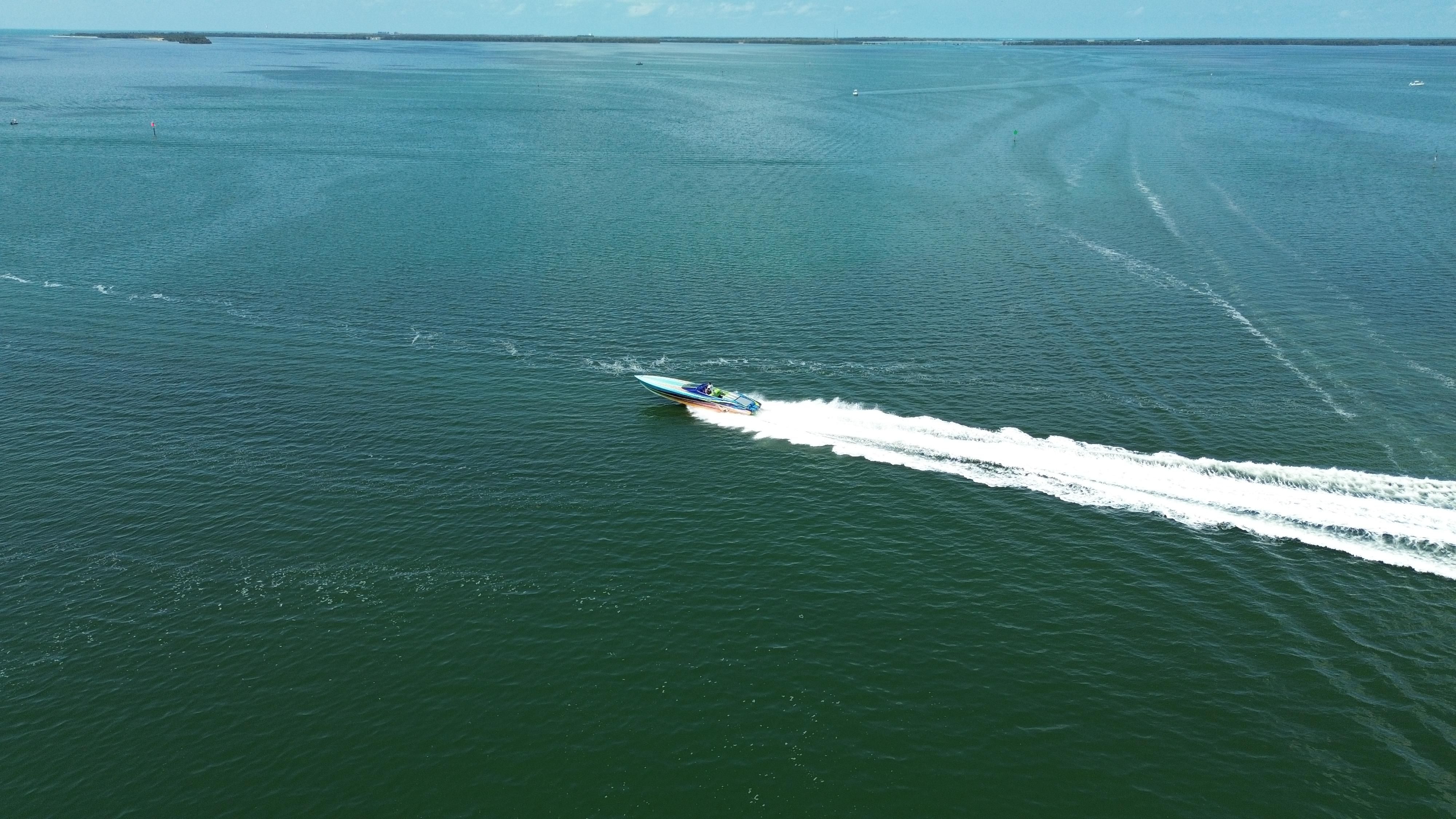 Aerial view of 2008 Outerlimits 39 Quattro speedboat cruising on open water.