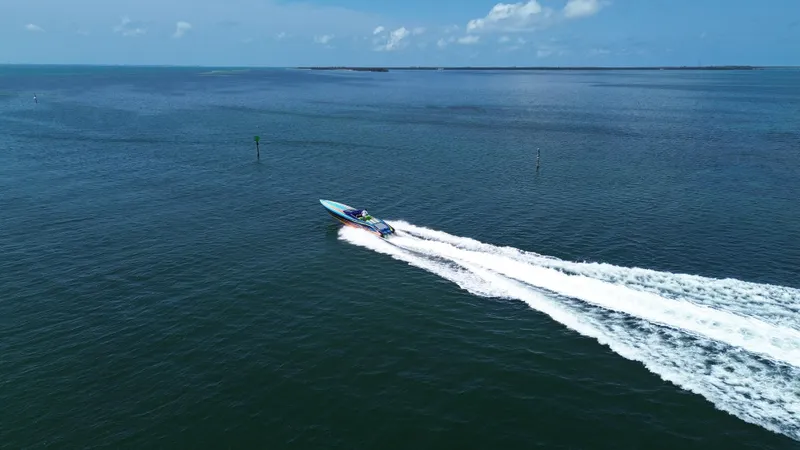  Yacht Photos Pics 2008 Outerlimits 39 Quattro speedboat cruising on open water under a clear blue sky.