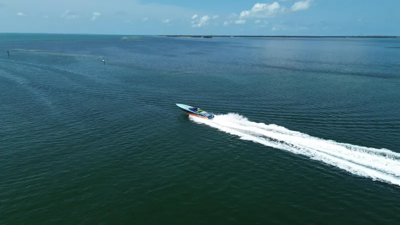  Yacht Photos Pics Aerial view of 2008 Outerlimits 39 Quattro speedboat cruising on open water.