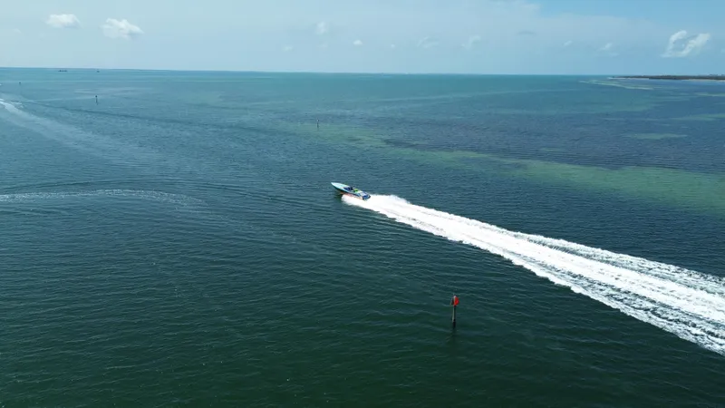 Yacht Photos Pics Aerial view of 2008 Outerlimits 39 Quattro speedboat cruising on open water.
