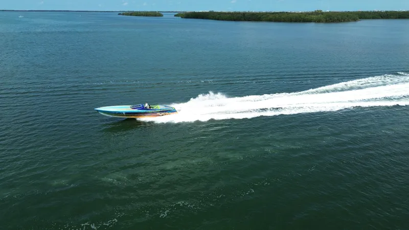  Yacht Photos Pics 2008 Outerlimits 39 Quattro speedboat cruising on open water, leaving a white wake trail.
