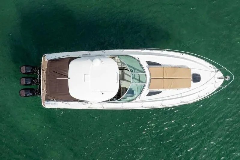  Yacht Photos Pics Overhead view of 2010 Sea Ray 370 Sundancer yacht on green water.