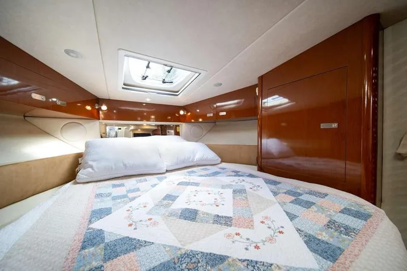  Yacht Photos Pics Luxurious cabin interior of 2010 Sea Ray 370 Sundancer with quilted bedding.