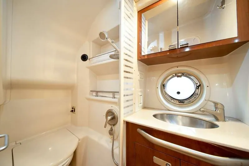  Yacht Photos Pics Luxurious bathroom in 2010 Sea Ray 370 Sundancer yacht with porthole and modern fixtures.