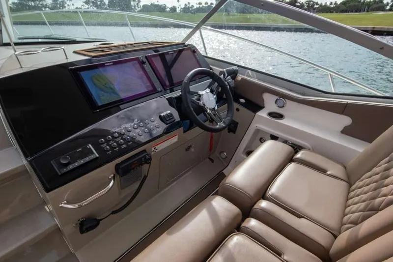  Yacht Photos Pics 2010 Sea Ray 370 Sundancer helm with modern navigation system and luxurious seating.