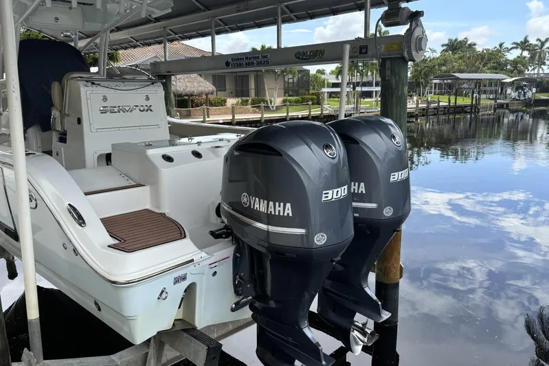  Yacht Photos Pics 2017 Sea Fox 288 Commander with twin Yamaha 300 engines docked by a serene waterfront.