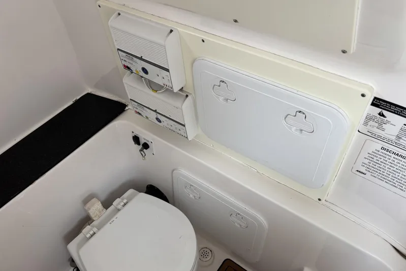  Yacht Photos Pics 2017 Sea Fox 288 Commander boat bathroom with toilet and control panels.