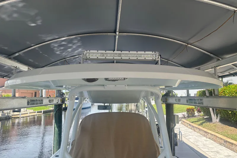  Yacht Photos Pics 2017 Sea Fox 288 Commander boat under covered dock, side view.