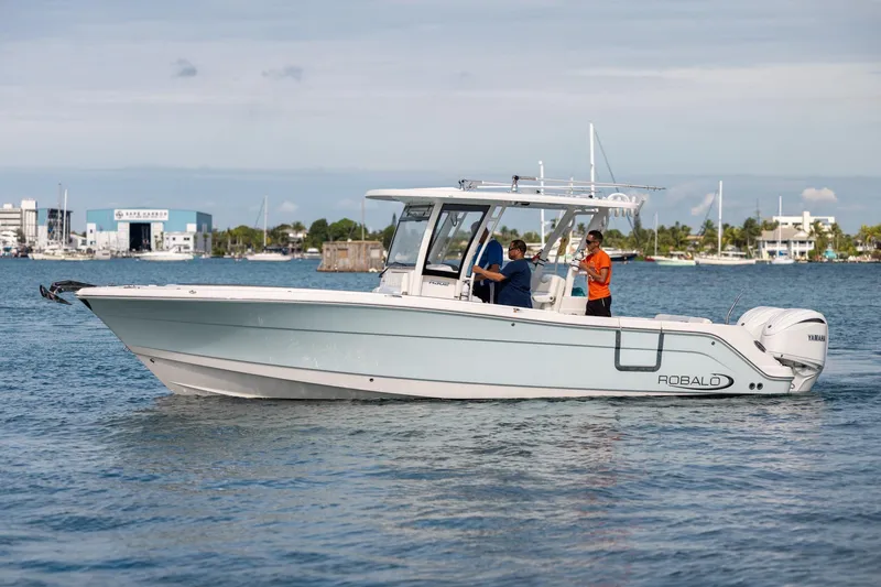  Yacht Photos Pics 2023 Robalo R302 Center Console boat cruising on calm waters.