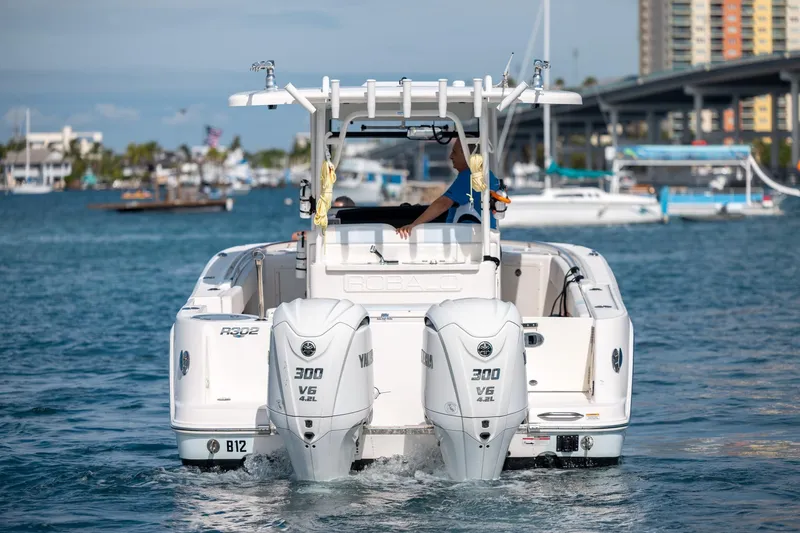  Yacht Photos Pics 2023 Robalo R302 Center Console boat with dual Yamaha 300 V6 engines on water.