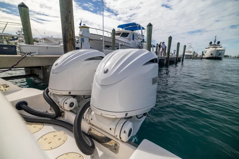  Yacht Photos Pics 2023 Robalo R302 Center Console with dual outboard engines at marina.