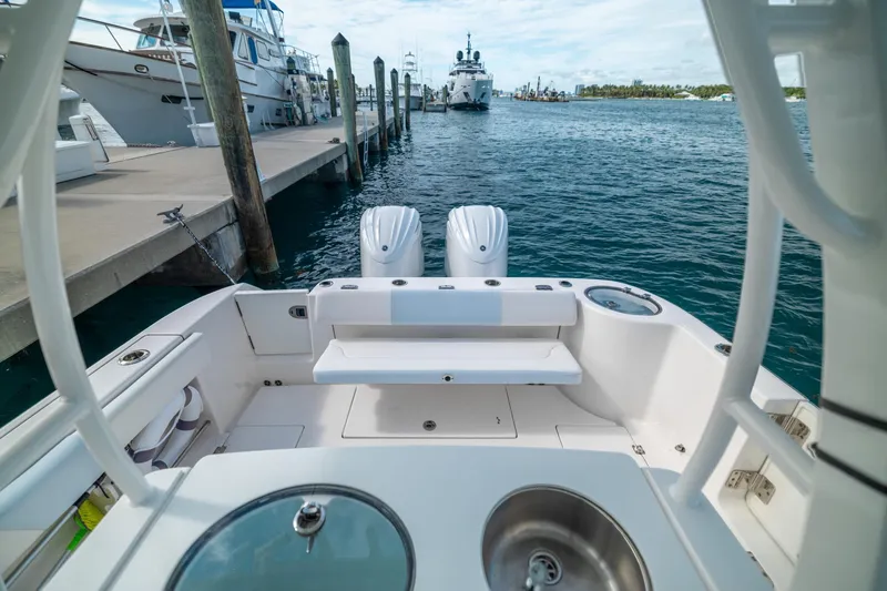 Yacht Photos Pics 2023 Robalo R302 Center Console boat docked at marina with dual engines.
