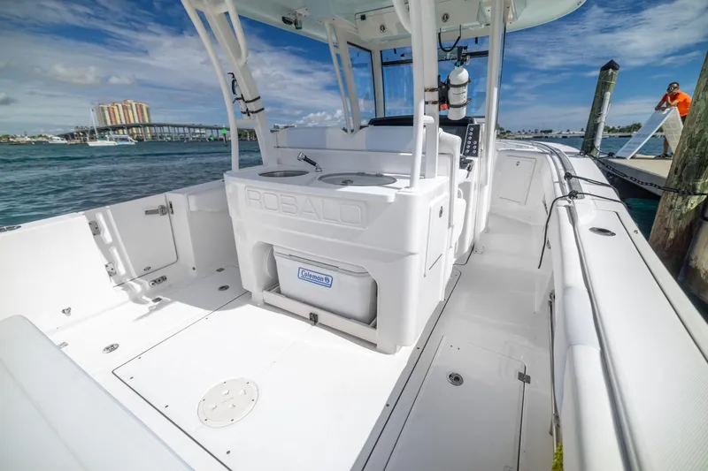  Yacht Photos Pics 2023 Robalo R302 Center Console boat docked, showcasing spacious deck and modern design.