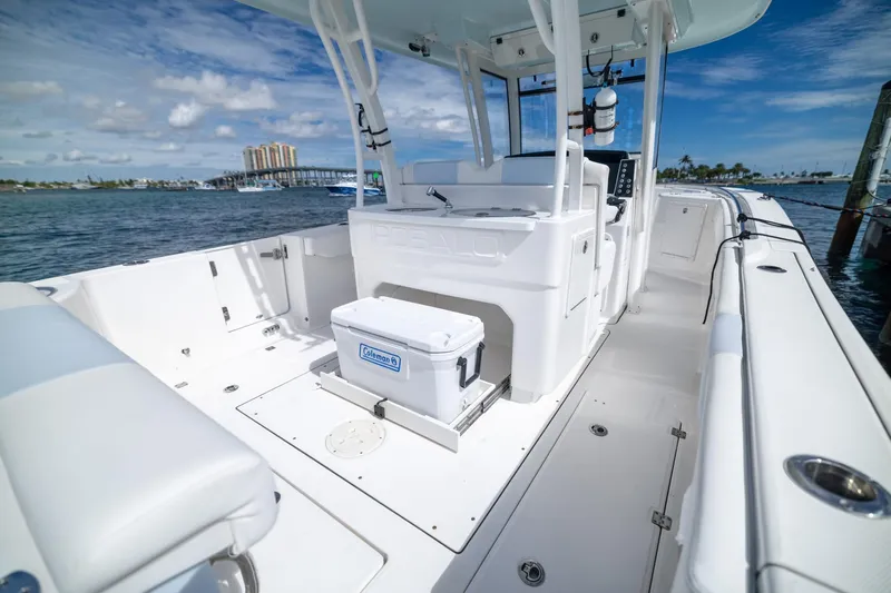  Yacht Photos Pics 2023 Robalo R302 Center Console boat interior with ocean view and cooler.