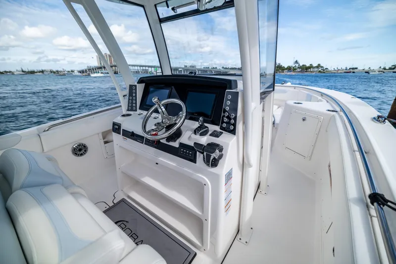  Yacht Photos Pics 2023 Robalo R302 Center Console boat interior with modern helm and ocean view.