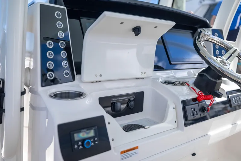  Yacht Photos Pics 2023 Robalo R302 Center Console dashboard with steering wheel and control panel.