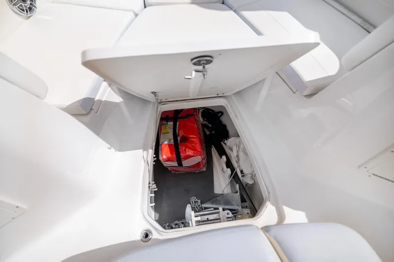  Yacht Photos Pics 2023 Robalo R302 Center Console storage compartment with safety gear and equipment.