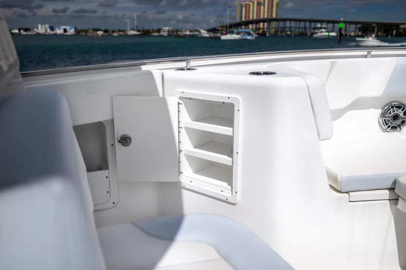  Yacht Photos Pics 2023 Robalo R302 Center Console boat interior with storage compartments and seating.