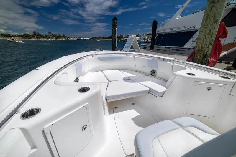  Yacht Photos Pics 2023 Robalo R302 Center Console boat interior with white seating and ocean view.