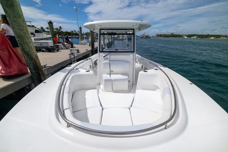 Yacht Photos Pics 2023 Robalo R302 Center Console boat docked, featuring spacious seating and sleek design.