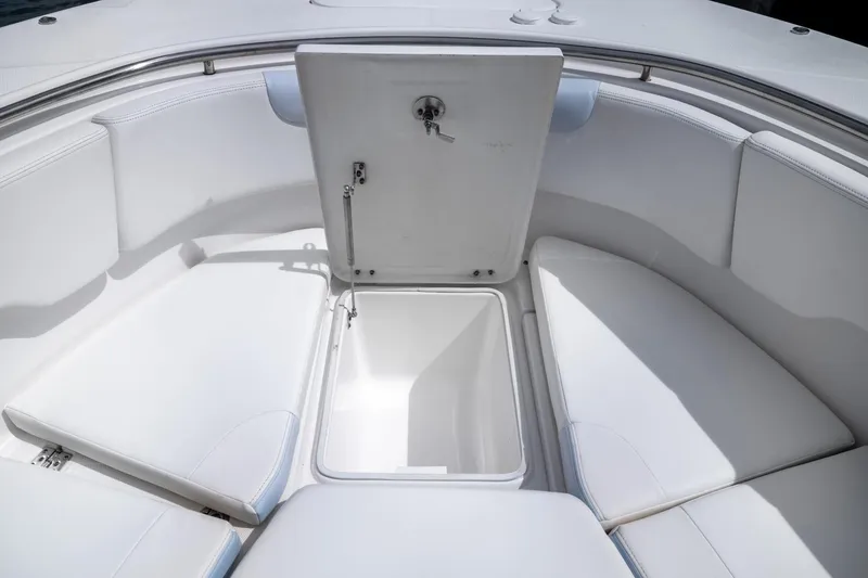  Yacht Photos Pics 2023 Robalo R302 Center Console boat with open storage compartment and cushioned seating.