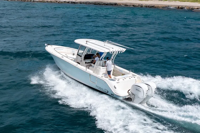 Yacht Photos Pics 2023 Robalo R302 Center Console boat cruising on open water.