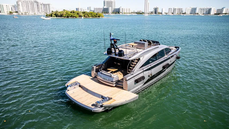  Yacht Photos Pics 2025 Pershing GTX 80 yacht on water, city skyline in background.