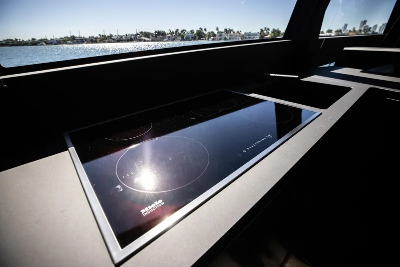  Yacht Photos Pics Modern induction cooktop on Pershing GTX 80 yacht, 2025 model, with scenic water view.