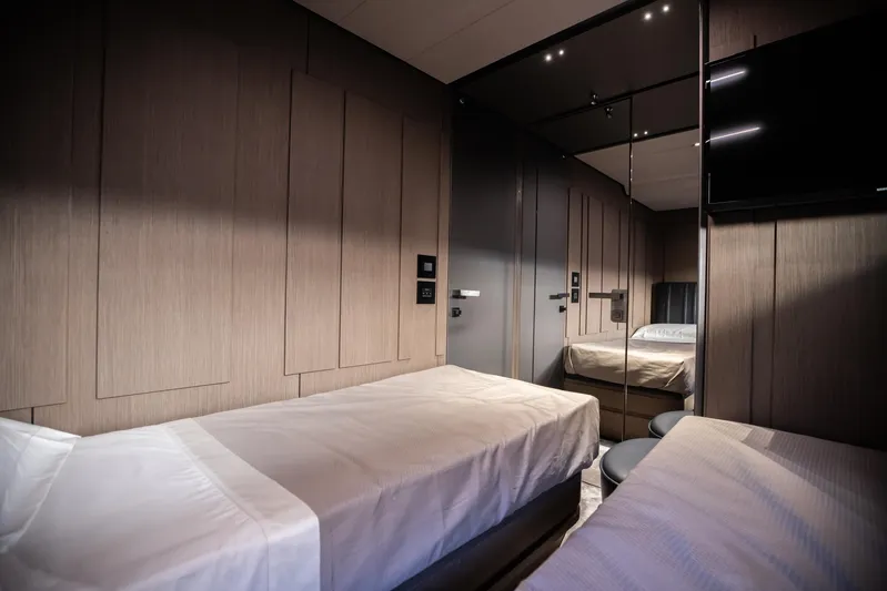  Yacht Photos Pics Luxurious twin bedroom interior on 2025 Pershing GTX 80 yacht, featuring modern design and ambient lighting.