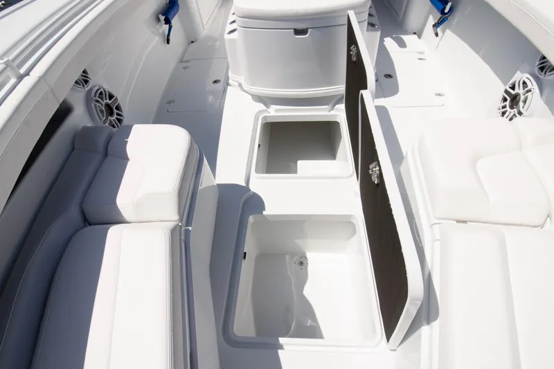  Yacht Photos Pics 2026 Yellowfin 36 Offshore boat interior with open storage compartments and cushioned seating.