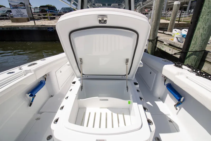  Yacht Photos Pics 2026 Yellowfin 36 Offshore boat with open storage compartment at dockside.