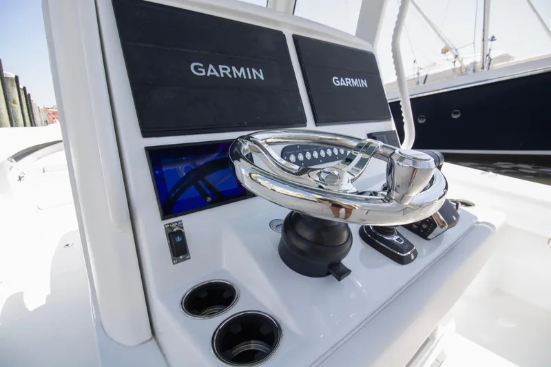  Yacht Photos Pics 2026 Yellowfin 36 Offshore boat helm with Garmin displays and chrome steering wheel.