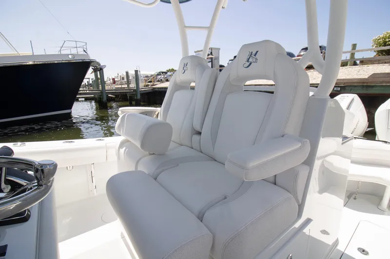  Yacht Photos Pics 2026 Yellowfin 36 Offshore boat with luxurious white seating at a marina.