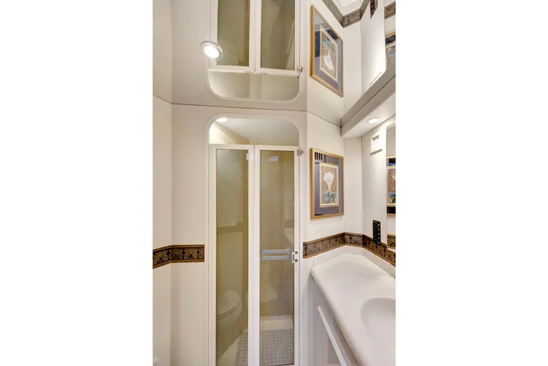 Lady S Yacht Photos Pics Luxurious bathroom interior of 2001 Viking 50 Convertible yacht with elegant decor.