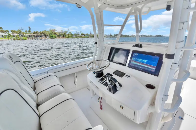  Yacht Photos Pics 2017 Jupiter 34 FS boat cockpit with modern navigation screens and comfortable seating.