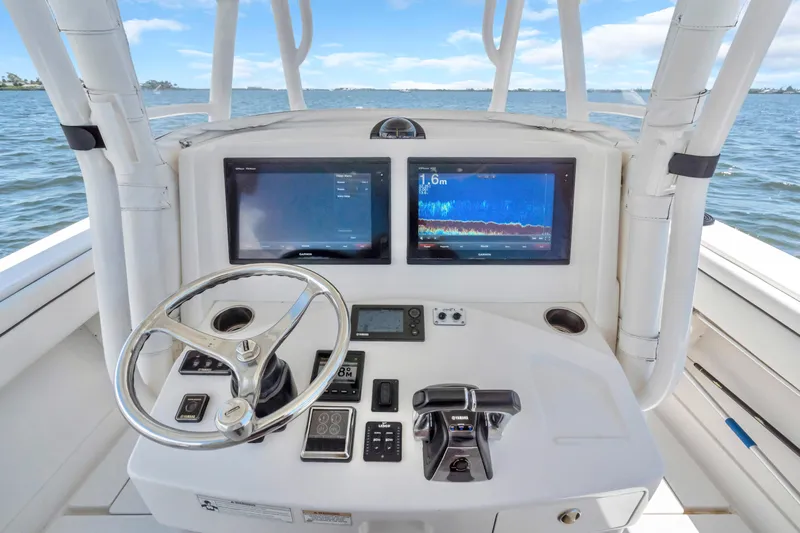  Yacht Photos Pics 2017 Jupiter 34 FS boat console with dual displays and steering wheel on open water.