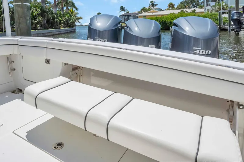  Yacht Photos Pics 2017 Jupiter 34 FS boat with triple Yamaha 300 engines, docked near lush greenery.